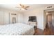 Bedroom featuring a hardwood floor, ceiling fan, and an adjacent hallway at 2359 W Del Oro Cir, Mesa, AZ 85202