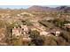 An aerial view showing the estate's extensive tile roof, tennis court, and surrounding desert landscape at 23779 N 91St St, Scottsdale, AZ 85255