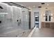 Modern bathroom with sleek glass enclosed shower, rainfall shower head, and vanity at 23779 N 91St St, Scottsdale, AZ 85255