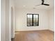 Bedroom featuring wood floors, a large window with a view, and an arched entrance at 23779 N 91St St, Scottsdale, AZ 85255