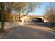 Long driveway with desert landscaping leading to a covered entrance gate at 23779 N 91St St, Scottsdale, AZ 85255