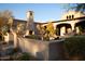 Charming outdoor living area showcases a cozy fireplace, desert landscaping and architectural details at 23779 N 91St St, Scottsdale, AZ 85255