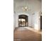 The foyer features a herringbone inlay, arched ceilings and modern lighting, creating an elegant entry at 23779 N 91St St, Scottsdale, AZ 85255