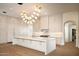 Spacious kitchen features an island with marble countertops and modern cabinetry at 23779 N 91St St, Scottsdale, AZ 85255