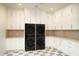 Laundry room with lots of white cabinets, and a stackable washer and dryer at 23779 N 91St St, Scottsdale, AZ 85255