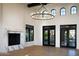 Light-filled living room with marble fireplace, modern lighting, and access to a beautifully landscaped backyard at 23779 N 91St St, Scottsdale, AZ 85255