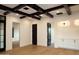 Spacious living room features wood floors, beamed ceilings, custom built-ins, and access to other rooms at 23779 N 91St St, Scottsdale, AZ 85255