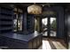 Dark and moody office with black trim, custom millwork, chandelier, and outdoor patio at 23779 N 91St St, Scottsdale, AZ 85255