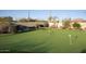 Private putting green in backyard with lush landscaping and multiple holes at 23779 N 91St St, Scottsdale, AZ 85255