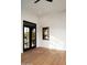 Room with black framed windows and doors, wood floors, and view of outdoor patio at 23779 N 91St St, Scottsdale, AZ 85255