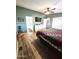 View of a bedroom, showcasing the ceiling fan and flat screen television mounted on the wall at 2400 E Baseline Ave # 58, Apache Junction, AZ 85119