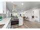 Modern kitchen with stainless steel appliances open to the living and dining area at 2418 W Flower St, Phoenix, AZ 85015