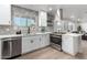 Bright kitchen featuring stainless appliances, quartz countertops, and stylish backsplash at 2418 W Flower St, Phoenix, AZ 85015