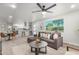 Open-concept living room with modern furnishings, dining area, and seamless flow to the updated kitchen at 2418 W Flower St, Phoenix, AZ 85015