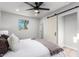 Bright bedroom showcasing a ceiling fan, sliding barn door, and ample natural light at 2418 W Flower St, Phoenix, AZ 85015