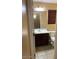 Bathroom featuring dark cabinets, a mirror, tile floor, and a toilet at 25532 W Williams W St, Buckeye, AZ 85326