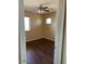 Cozy bedroom with ceiling fan, wood-look flooring, and natural light from the windows at 25532 W Williams W St, Buckeye, AZ 85326