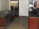 Kitchen featuring stainless steel appliances, dark cabinets, granite countertops, and tile floors at 25532 W Williams W St, Buckeye, AZ 85326