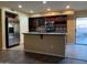 Open kitchen with stainless steel appliances, a center island, dark cabinets, and sliding door to patio at 25532 W Williams W St, Buckeye, AZ 85326