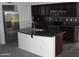 Modern kitchen featuring dark cabinets, stainless steel appliances, granite countertops, and a center island at 25532 W Williams W St, Buckeye, AZ 85326