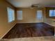 Living room featuring hardwood floors, large windows, and a ceiling fan at 25532 W Williams W St, Buckeye, AZ 85326