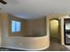 Living room featuring hardwood floors, a half wall, and an open doorway to the kitchen at 25532 W Williams W St, Buckeye, AZ 85326