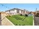 Lush backyard featuring artificial turf, a relaxing hammock, and views of the sparkling pool at 25945 W Sands Dr, Buckeye, AZ 85396