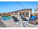 Backyard with a pool, seating area, and covered patio at 25945 W Sands Dr, Buckeye, AZ 85396