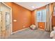 ' bedroom with orange walls, gray carpet, and a view from the doorway at 25945 W Sands Dr, Buckeye, AZ 85396
