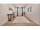 The foyer features wood-look floors, a console table, neutral walls, and a statement rug at 25945 W Sands Dr, Buckeye, AZ 85396