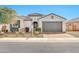Charming single-story home features a stucco exterior, tile roof, arched entry, and a two-car garage at 25945 W Sands Dr, Buckeye, AZ 85396