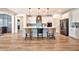 Bright kitchen with white cabinets, a center island, pendant lighting, and stainless steel appliances at 25945 W Sands Dr, Buckeye, AZ 85396