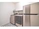 Laundry room with stainless steel appliances and patterned tile floor at 25945 W Sands Dr, Buckeye, AZ 85396