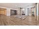 Bright living room features wood-look flooring, shiplap accent wall, and a decorative fireplace with a built-in display case at 25945 W Sands Dr, Buckeye, AZ 85396