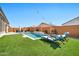 Inviting pool area with lounge chairs and well-manicured artificial turf, perfect for relaxation and outdoor enjoyment at 25945 W Sands Dr, Buckeye, AZ 85396