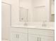 Bright bathroom featuring a double vanity, framed mirror, and glass enclosed shower at 2673 E San Miguel Dr, Casa Grande, AZ 85194