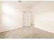 A well-lit bedroom with a closet and neutral carpeting at 2673 E San Miguel Dr, Casa Grande, AZ 85194