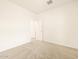 Bright bedroom with neutral carpet and a doorway leading to another room at 2673 E San Miguel Dr, Casa Grande, AZ 85194