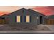 Charming single-story home featuring blue shutters and low-maintenance landscaping against a vibrant sunset backdrop at 2673 E San Miguel Dr, Casa Grande, AZ 85194