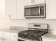 Close-up of kitchen features including stainless steel microwave and oven with white cabinetry at 2673 E San Miguel Dr, Casa Grande, AZ 85194