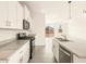 Kitchen featuring stainless steel appliances, granite countertops, white cabinetry, and view of the backyard at 2673 E San Miguel Dr, Casa Grande, AZ 85194
