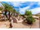 Secluded backyard with custom fire pit and lounge area surrounded by desert vegetation at 32177 N Echo Canyon Rd, San Tan Valley, AZ 85143