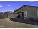 Low-maintenance backyard with gravel, privacy wall, and covered patio at 36602 W San Alvarez Ave, Maricopa, AZ 85138