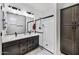 Bathroom showcasing double sinks, granite countertops, and a glass-enclosed shower at 36602 W San Alvarez Ave, Maricopa, AZ 85138