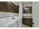 Well-organized laundry room with granite countertops, upper cabinets, washer, and dryer at 36602 W San Alvarez Ave, Maricopa, AZ 85138