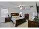Bright bedroom with large windows, a ceiling fan, and well-crafted wood furniture at 36602 W San Alvarez Ave, Maricopa, AZ 85138