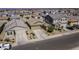 Aerial view of a well-maintained home in a neighborhood with desert landscaping and attached garage at 36602 W San Alvarez Ave, Maricopa, AZ 85138