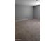 A large carpeted bedroom with light gray walls and bright lighting at 374 S Verdad Ln, Casa Grande, AZ 85194