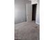 A modest bedroom with neutral carpet, gray walls, and a white door is ready for personalization at 374 S Verdad Ln, Casa Grande, AZ 85194