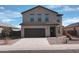 A modern two-story home with a dark garage door and desert landscaping at 374 S Verdad Ln, Casa Grande, AZ 85194